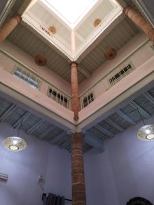 a ceiling in a room with a pillar and lights at RIAD MAROSKO in Essaouira