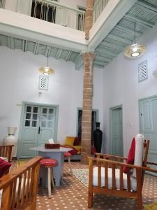 a living room with a couch and a table at RIAD MAROSKO in Essaouira