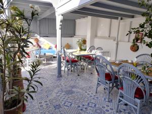 a patio with a table and chairs on a floor at RIAD MAROSKO in Essaouira
