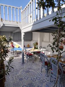 a patio with a table and chairs and a staircase at RIAD MAROSKO in Essaouira