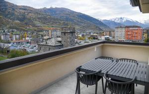 a table and chairs on a balcony with a view at JUPILUC in Aosta