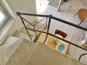 an overhead view of a staircase with a chair at Fournos in Kimolos