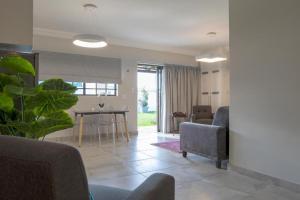 a living room with chairs and a table and a dining room at Arcangeli Wines in Botrivier