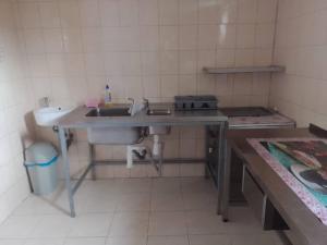 a small kitchen with a sink and a sink at Penzion Anna in Hrabušice