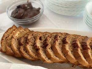 a loaf of bread on a plate with chocolate at SEA & LAKE VIEW VILLA in (( Kalive Gjoka ))
