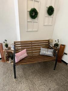 a wooden bench with two pillows on it next to a table at Hotel zur Altstadt in Celle