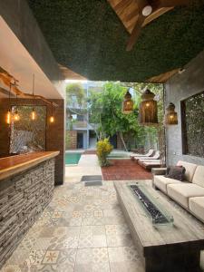 a living room with a couch and a table at Little Gem Hotel Tulum La Veleta in Tulum