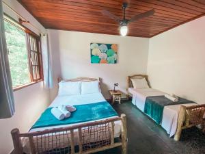 a bedroom with two beds in a room at Pousada do Canto in Abraão