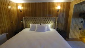 a large white bed with two pillows in a room at Ayder Villa de Pelit Hotel in Ayder Yaylasi