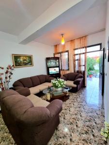 a living room with two couches and a television at GUEST HOUSE VILA ELEZI in Durrës