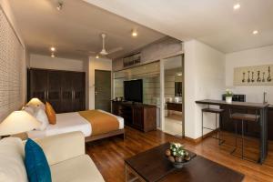 a hotel room with a bed and a living room at Rockwell Colombo in Colombo