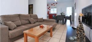 a living room with a couch and a giraffe statue at Casa Enrique in Cádiz