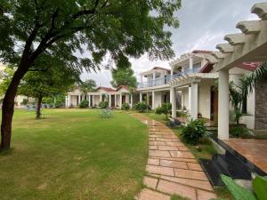 a large house with a lawn in front of it at Las Cabanas Resort in Pushkar