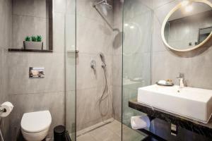 a bathroom with a shower and a toilet and a sink at Hotel Tuta in Tbilisi City