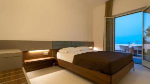 a bedroom with a bed and a view of the ocean at Terrazza sul Mare in Roseto degli Abruzzi