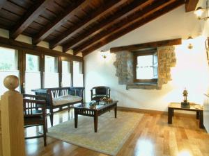 a living room with a couch and a table at La Casona De Baró in Baró