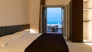 a bedroom with a bed with a view of the ocean at Terrazza sul Mare in Roseto degli Abruzzi