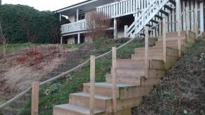 a set of stairs in front of a house at 3-rumslägenhet i villa med havsutsikt i Båstad Hindbärsvägen 22 in Båstad