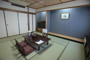 a rendering of a living room with a table and chairs at Yataro in Nagasaki +107 photos