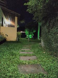 a walkway in the yard of a house at night at Pousada Abacateiro in Vale do Capao