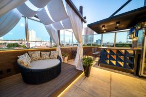 a balcony with a bed and curtains on a building at Hotel Meridional in Fortaleza