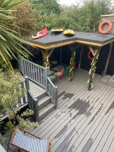 a wooden deck with a table and chairs on it at Ultimate glam, vintage central pad. Cool 70s bar. in Bournemouth