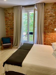 a bedroom with a large bed and a window at Marko&Luka in Sinj