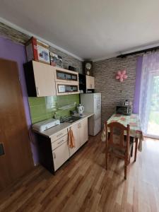 a kitchen with a table and a sink and a table and chairs at Wiejski Relax pod "Żelaznym szlakiem" in Jastrzębie Zdrój