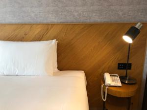 Postel nebo postele na pokoji v ubytování CHECK inn Select New Taipei Sanchong