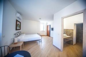 a bedroom with a bed and a room with a mirror at Around Lago Maggiore rooms in Reno Di Leggiuno