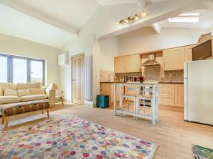 a kitchen and living room with a couch and a refrigerator at The Paddock in Shipston-on-Stour