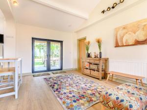 a living room with a table and a rug at The Paddock in Shipston-on-Stour