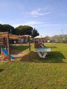 a playground with a slide in a park at Mobile home Comfort Ameglia - including airco - Camping River- 327 in Ameglia
