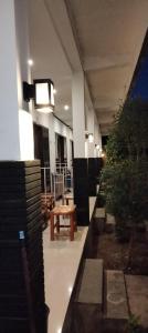 a hallway with a bench and plants in a building at Akalanka Homestay in Gili Trawangan
