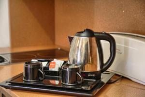 a tea kettle on a tray on a kitchen counter at San Marsial Benasque Apart Hotel in Benasque