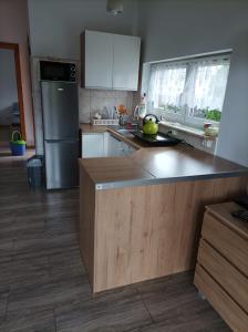 a kitchen with a counter top and a refrigerator at Dom nad jeziorem Charzykowy in Charzykowy