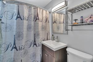 a bathroom with a sink and a shower curtain at Downtown Single Family Modern Bungalow close to beaches and dining home in Sarasota