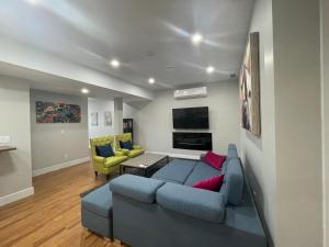 a living room with a blue couch and a yellow chair at Kaleden Guest Suite in Okanagan Falls