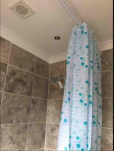 a bathroom with a shower with a glass wall at Nikolay’s House in Bristol