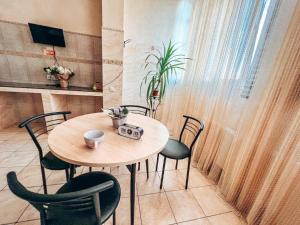 a table and chairs in a room with a table and a window at Pechersk House in Kyiv