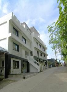 a large white building on a street at Boracay Suites in Boracay