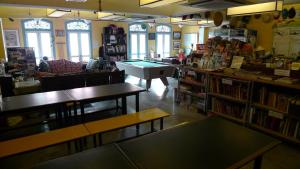 a book store with tables and a pool table at Betel Box Backpackers Hostel in Singapore