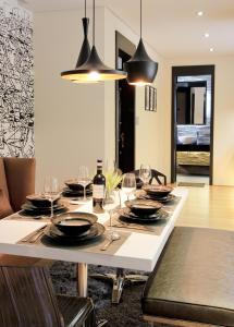 a dining room table with glasses and wine bottles on it at Boracay Suites in Boracay