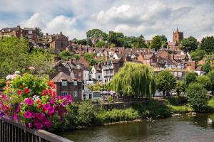 a view of a town with a river and flowers at Bridgnorth 24 Hour Self Check In with FREE Parking in Bridgnorth