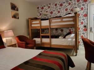 a bedroom with a bunk bed and a bedroom with a bed at The Royal Inn in St Austell