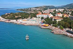 an aerial view of a beach with a boat in the water at Rooms by the sea Novi Vinodolski - 19837 in Novi Vinodolski