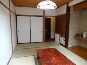 a kitchen with a table in a room at Ryokan Miyuki in Hakuba