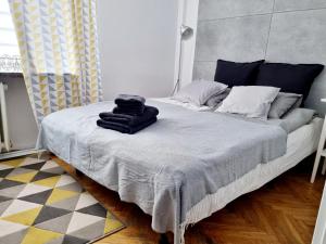 a bed with a blue blanket on top of it at Apartament Miodowa Warszawa in Warsaw