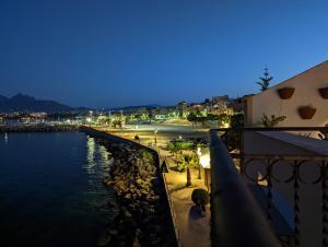 a view of a beach at night from a balcony at Casa nel borgo marinaro di Santa Nicolicchia in Santa Flavia