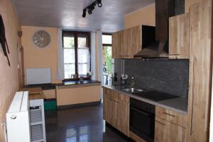 a kitchen with a sink and a stove top oven at Café du Pêcheurs in Bouillon